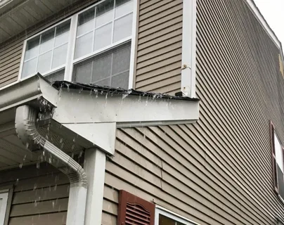 Gutter extensions directing rainwater away from a home’s foundation — professional gutter installation by Crystal Pro